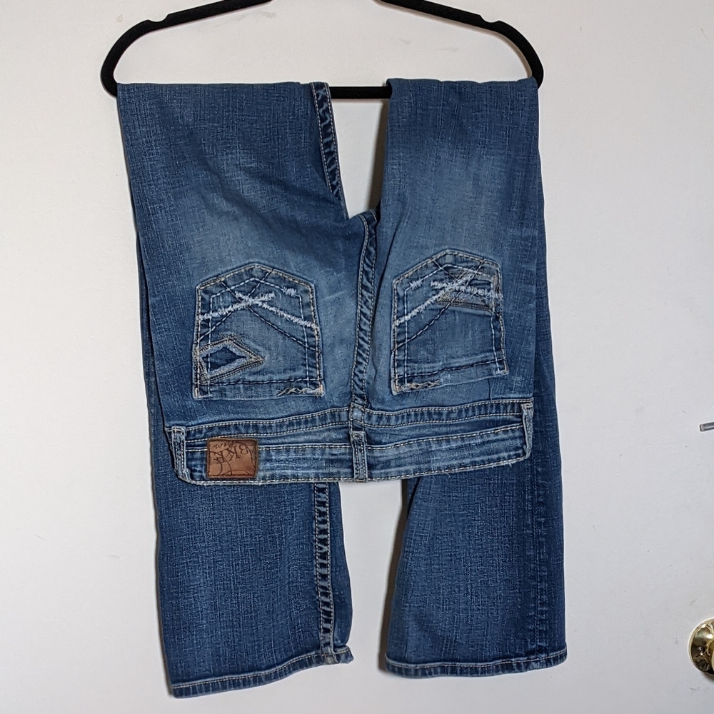 Buckle low-rise boot cut w/ factory distress marks